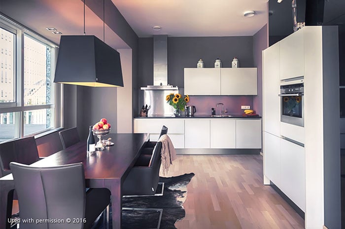 A contemporary kitchen design with white cabinets, a dark wood table, black-shaded overhead light and a hardwood floor.