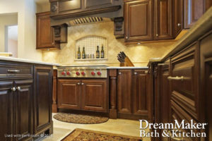  A kitchen remodel is displayed with a dark wood finish on the cabinets and an inset spice rack on the wall by the stove top.